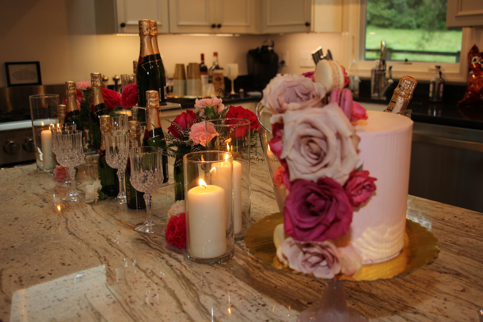 Custom moss-and-fresh-flower monogram letters displayed at a milestone celebration