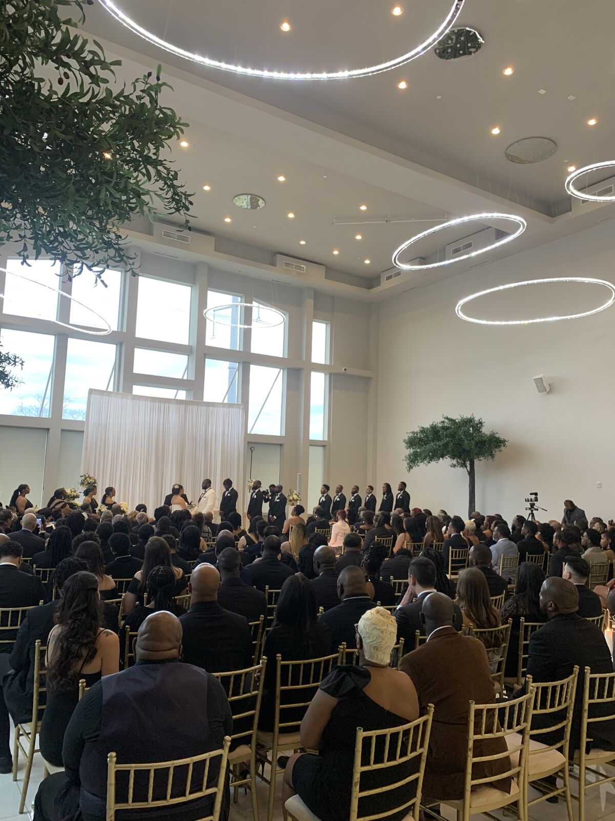 Seated guests during a ceremony in a bright modern event space