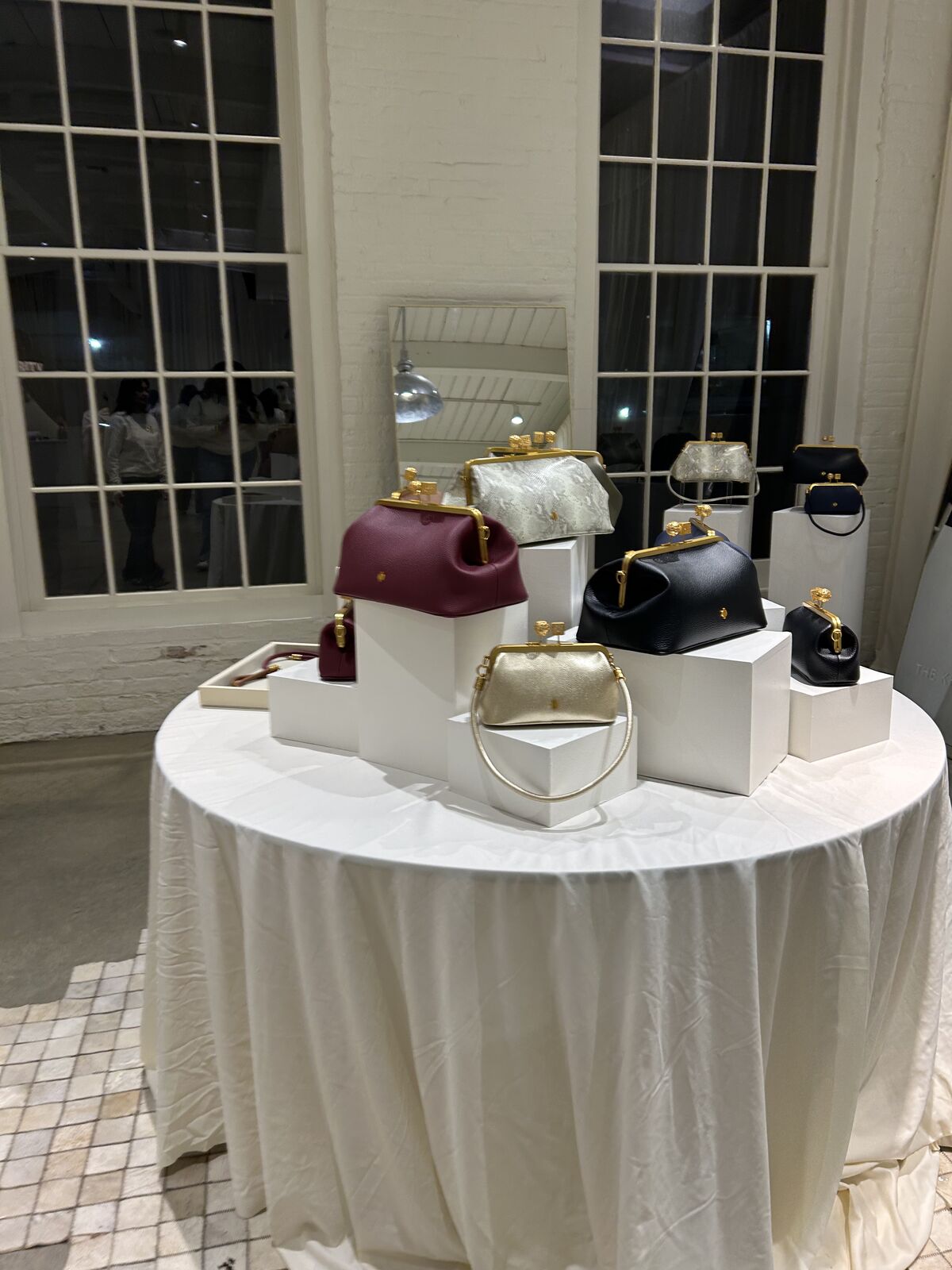 Curated gift display styled on a white linen round table